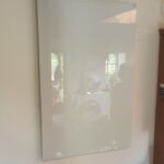 Infrared heating panel mounted vertically on the wall