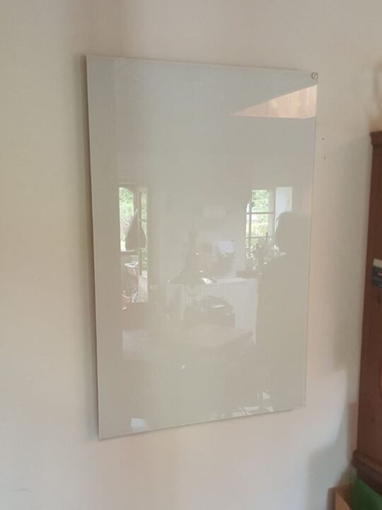 Infrared heating panel mounted vertically on the wall