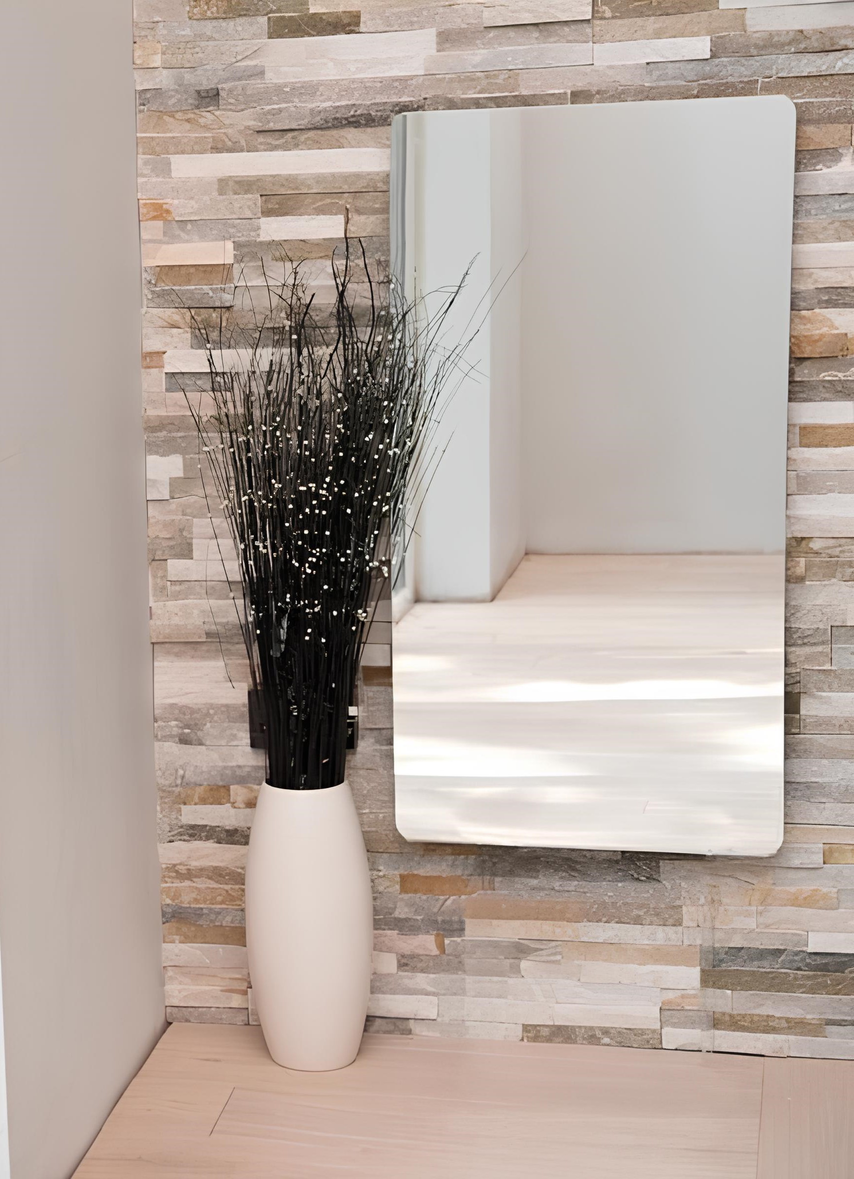 Mirror electric panel heater mounted on a wall in a hallway.