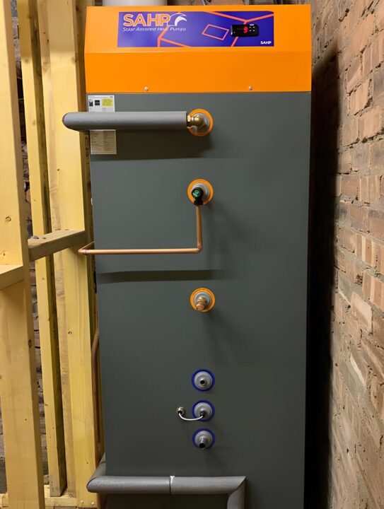 SAHP solar thermal heating boiler mounted on a brick wall.