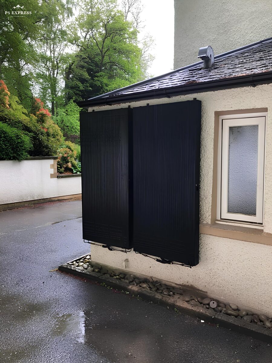 Two solar thermal panels mounted on the side of a house in Fife.