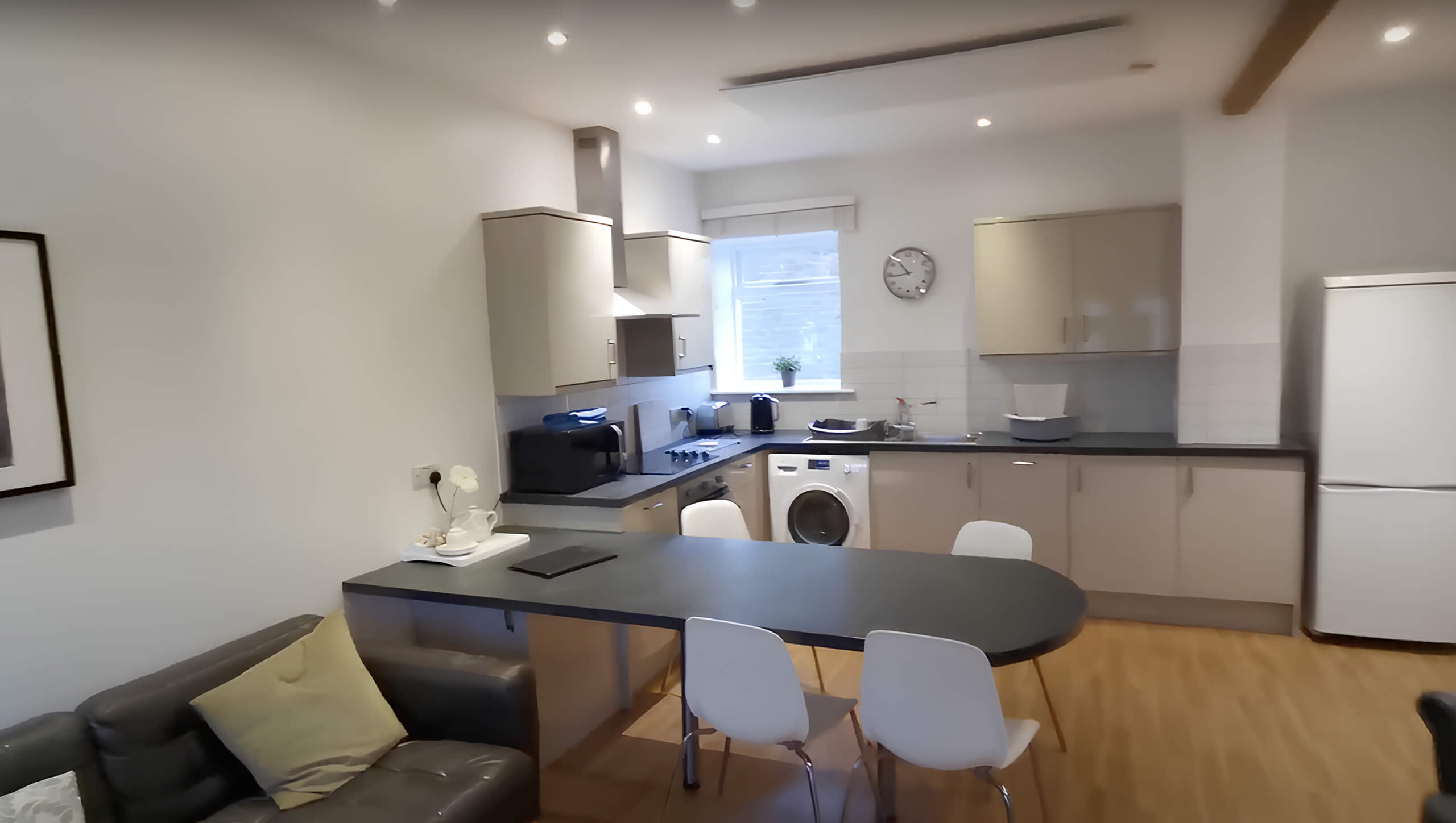 A modern kitchen with an infrared heating panel installed on the wall, offering energy-efficient heating without compromising on style.