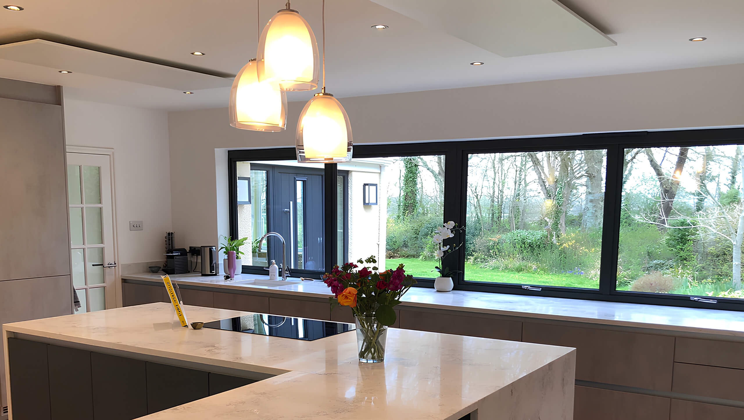 Energy-efficient infrared heating panel seamlessly installed in a contemporary open-plan kitchen.