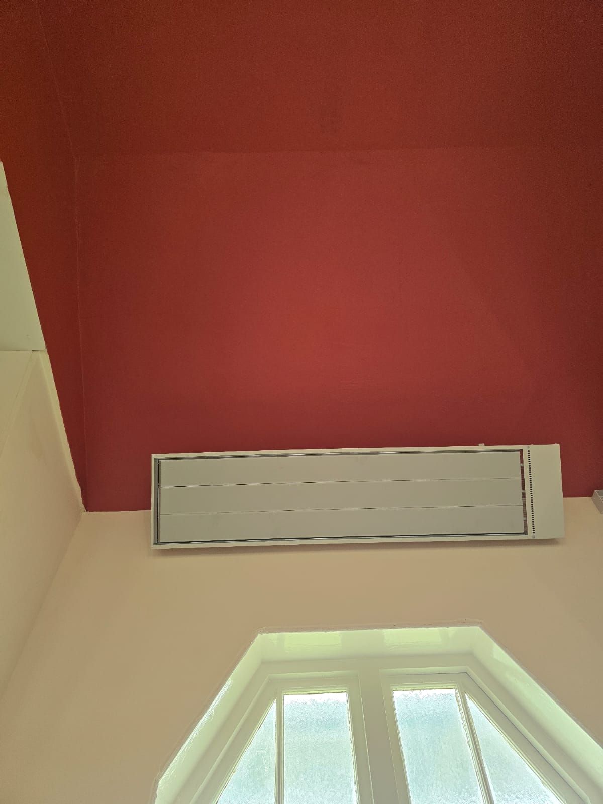 Infrared heater above an arched window